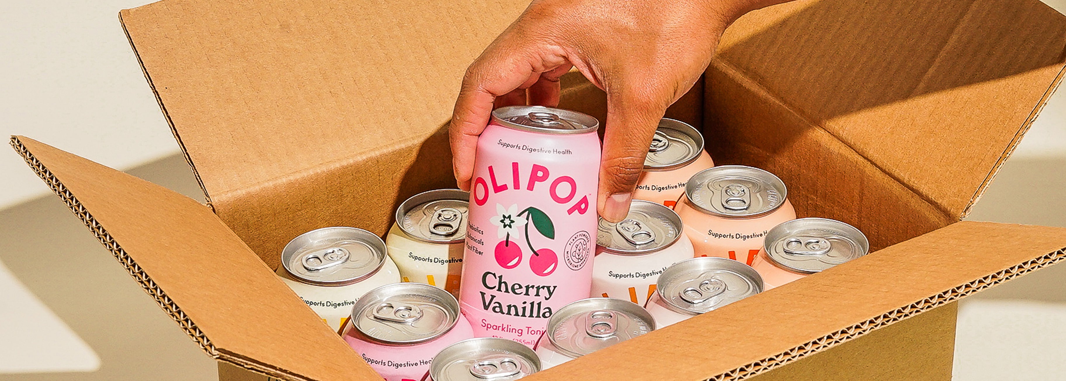Can of Cherry Vanilla being pulled from a box full of cans
